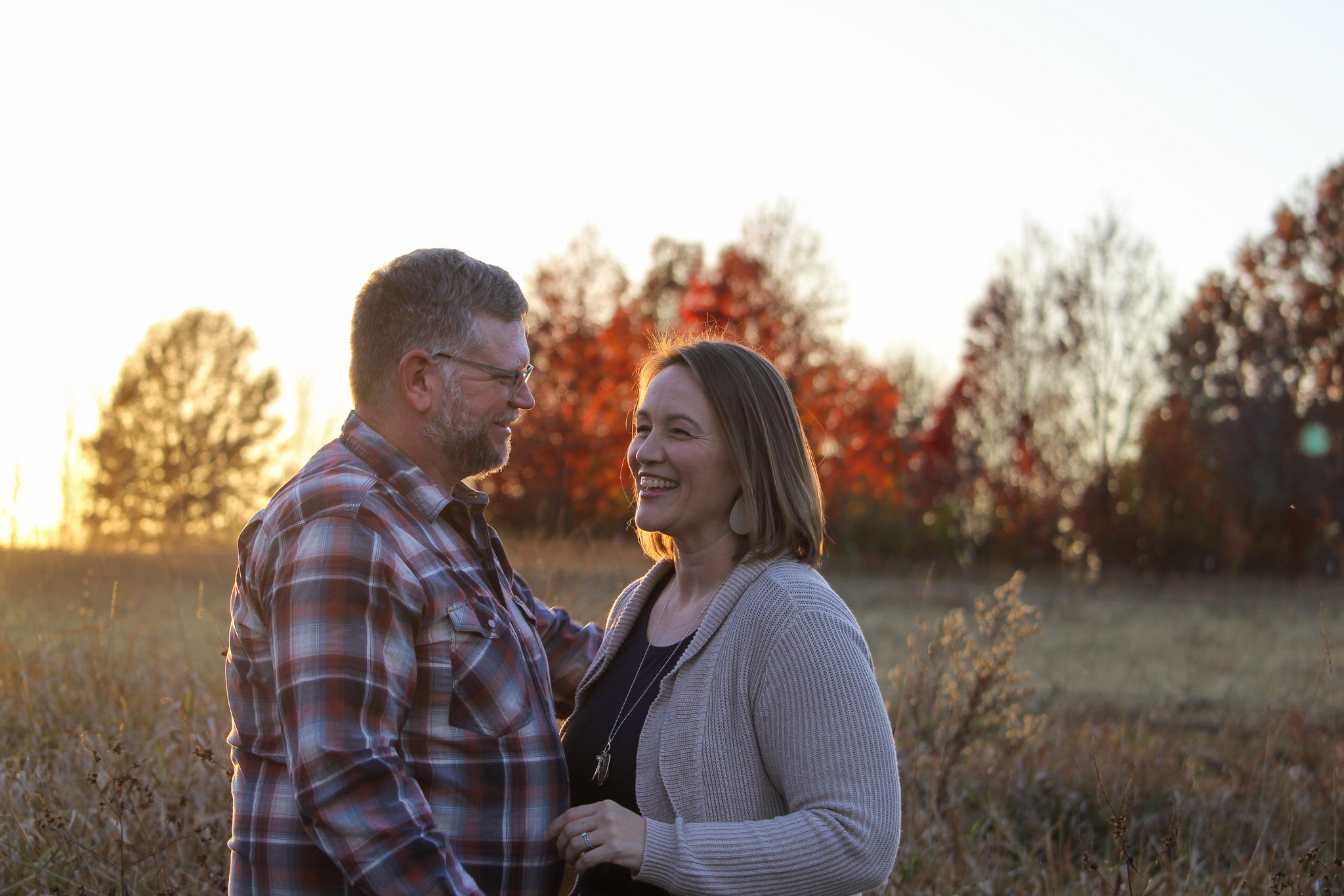 husband and wife smiling sunset photo