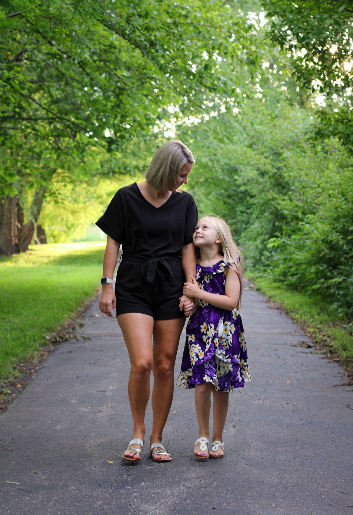 mom daughter walking smiling on park trail outdoor photo