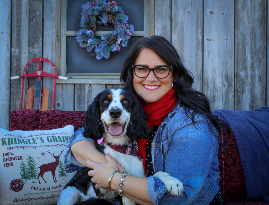 happy dog smiling with woman Christmas outdoor barn photo